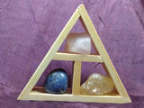 This handcrafted wooden triangle is made of fir and holds three stones and crystals intuitively selected to help you in your intentions of creative expression for artists and writers, although, any creative problem solving would be greatly enhanced with this collection. 