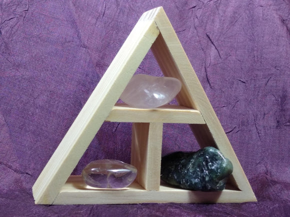 This handcrafted wooden triangle is made of fir and holds three stones and crystals intuitively selected to help you in your intentions of love.
