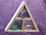 This wooden handcrafted triangle is made of fir and holds three stones and crystals intuitively selected to help you in your intentions for meditation. 