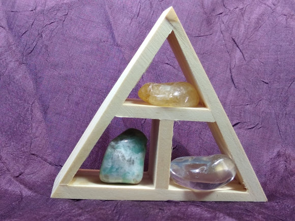 This handcrafted wooden triangle is made of fir and holds three stones and crystals intuitively selected to help you in your intentions for abundance and prosperity. 